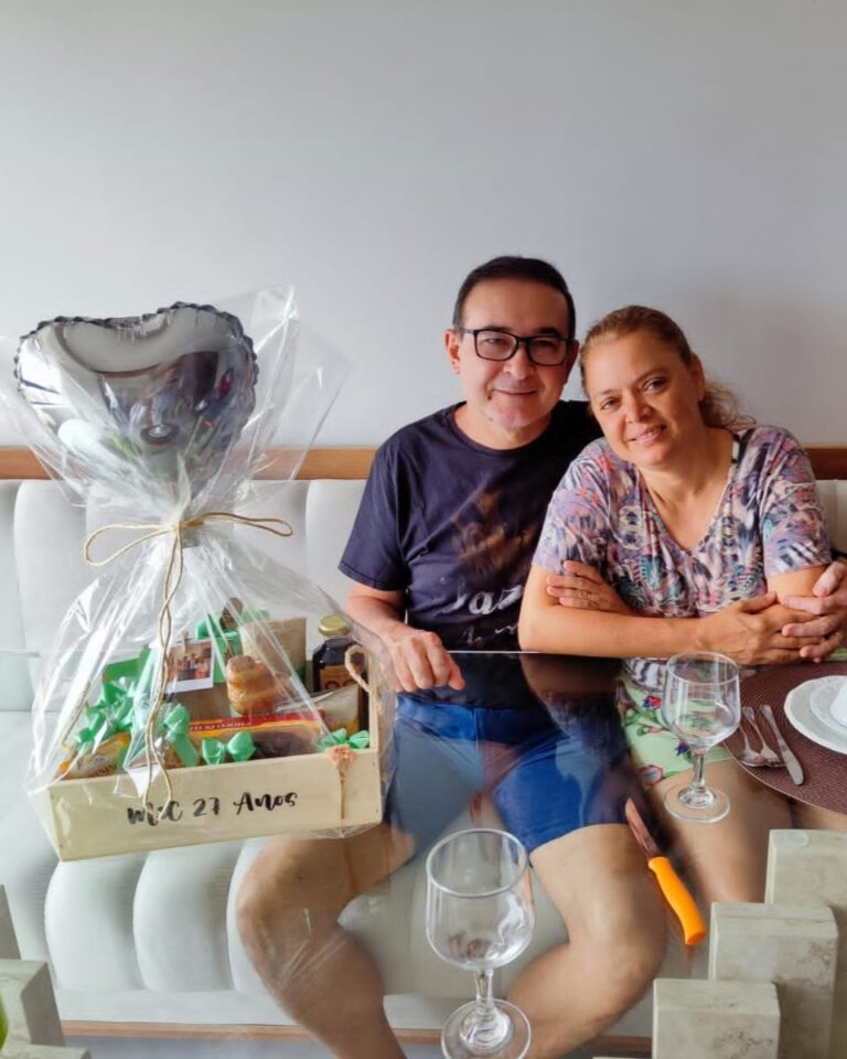 Casal, sorrindo e felizes, por receber uma linda Cesta de café da manhã, para comemorar seu aniversario de casamento.